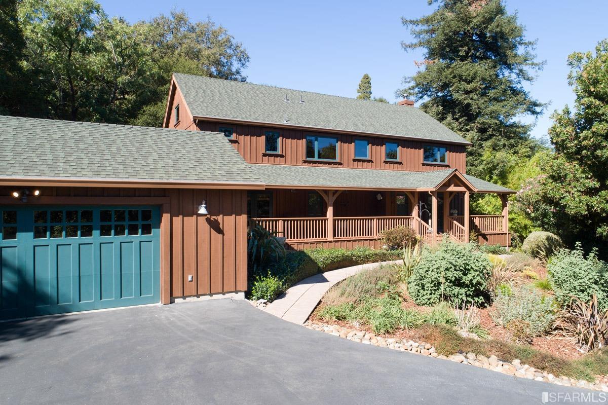 a front view of a house with a garden and plants