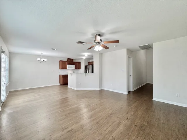 a view of a kitchen with a dishwasher cabinets and wooden floor
