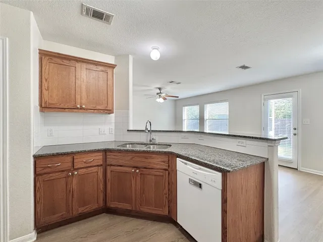 a kitchen with a sink stove and cabinets