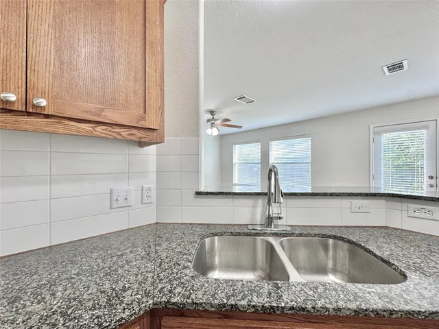 a kitchen with granite countertop a sink and granite top