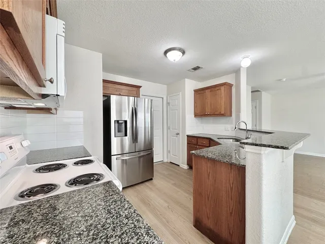 a kitchen with a refrigerator and a sink
