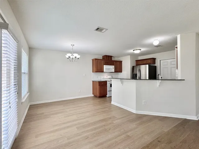 a view of a kitchen with a sink wooden floor and a window