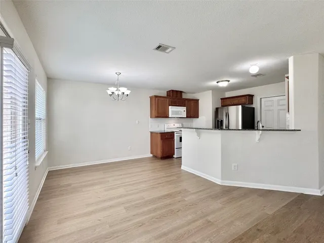 a view of a kitchen with a sink wooden floor and a window