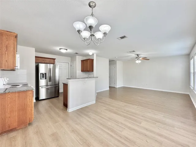 a view of a kitchen with a sink a microwave and cabinets