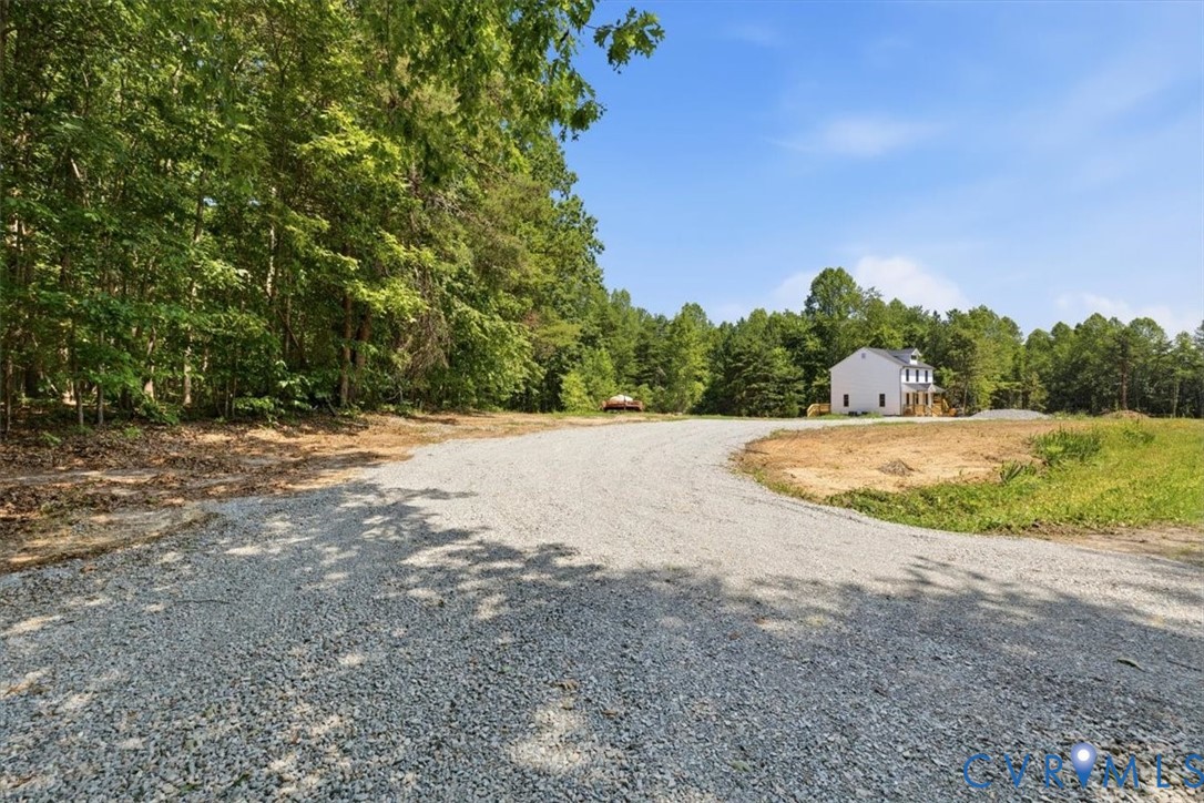 654 Frenchs Store Road Cumberland, VA 23040 - Photo 23 of 24 Gravel driveway approaching a two-story home with