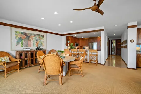 a dining room with furniture and a large window