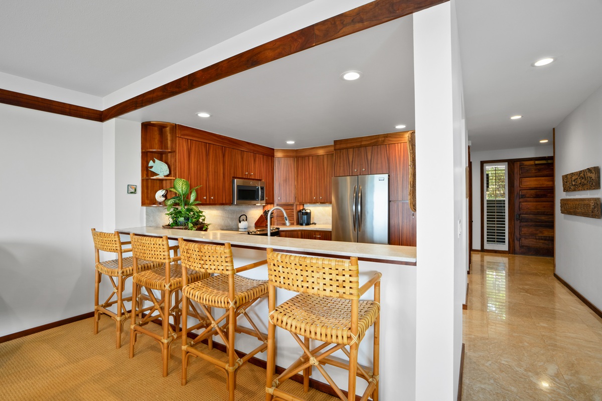 2640 Puuholo Road, Unit 115 Koloa, HI 96756 - Photo 15 of 20 a view of a kitchen with kitchen island granite countertop wooden cabinets and stainless steel appliances