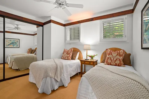 a bedroom with two beds and a window