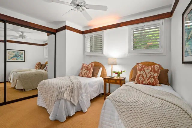 a bedroom with two beds and a window