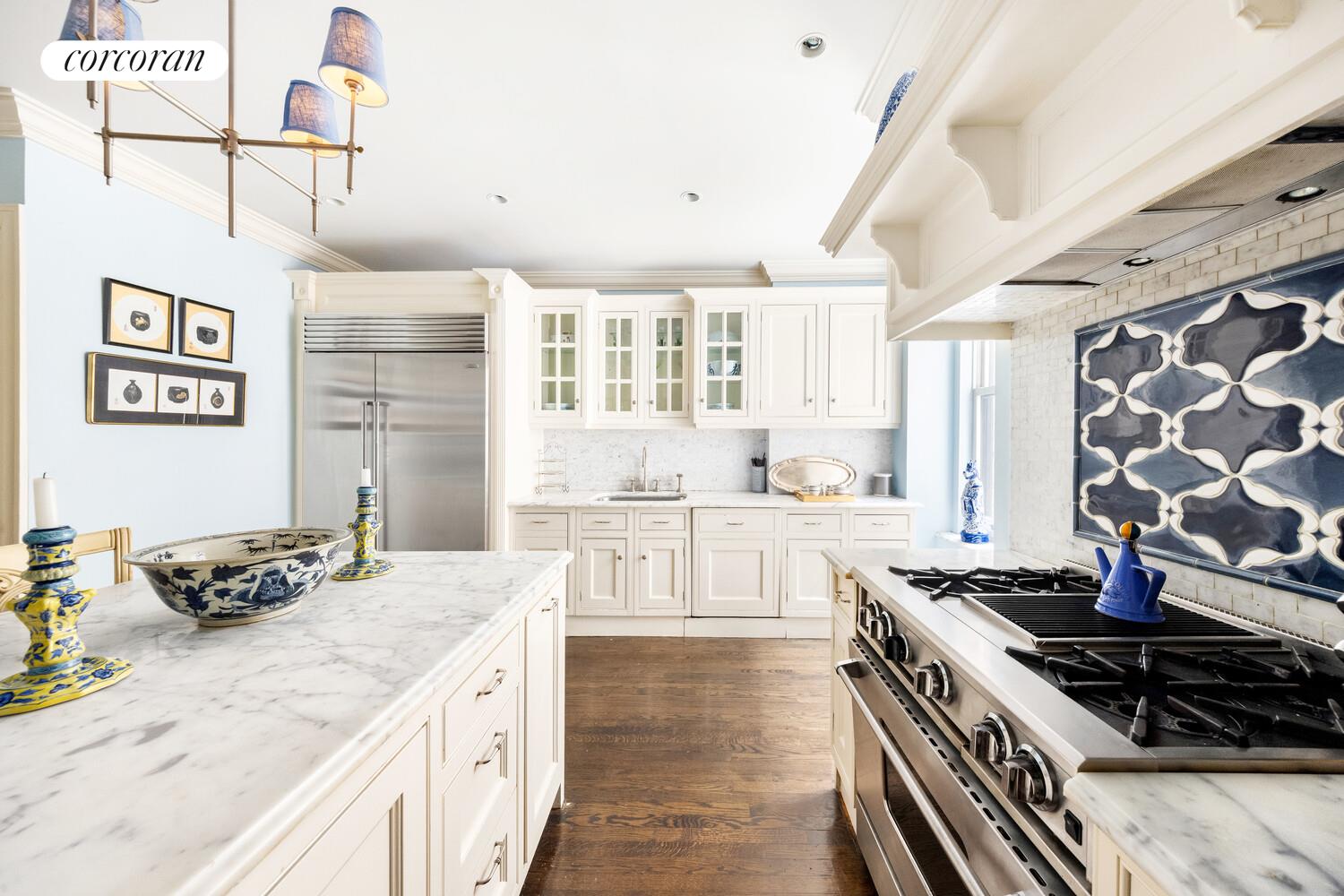 875 Park Avenue, Unit 8D9D Manhattan, NY 10075 - Photo 6 of 26 a kitchen with a stove a sink and a refrigerator