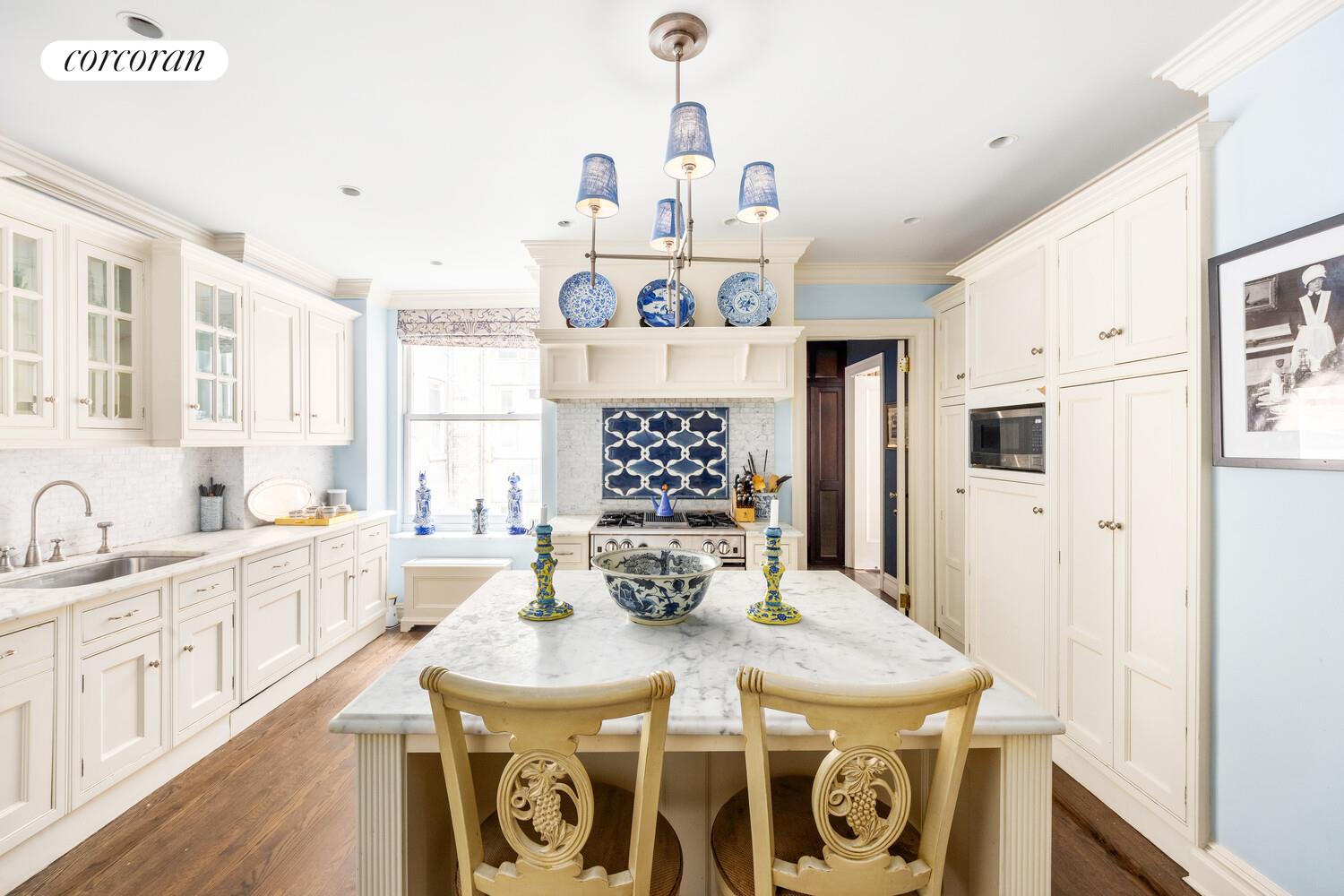 875 Park Avenue, Unit 8D9D Manhattan, NY 10075 - Photo 7 of 26 a view of a kitchen with kitchen island a chandelier