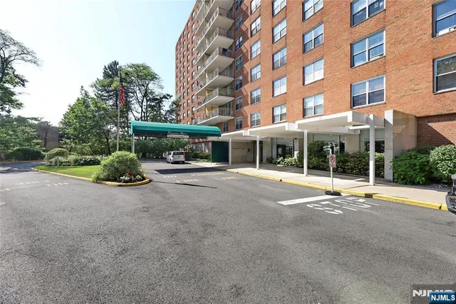 a view of a building with a garden and pathway