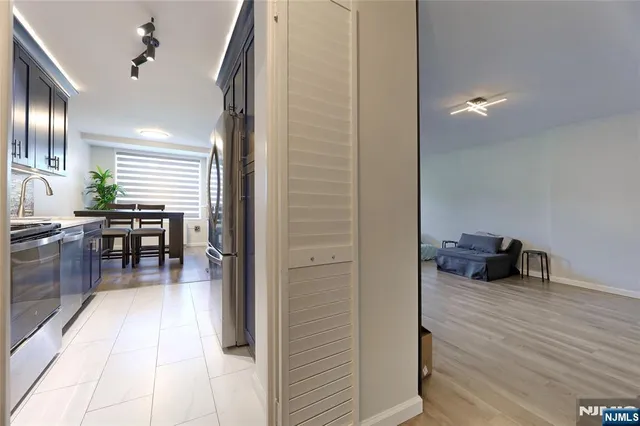 a kitchen with stainless steel appliances stove microwave refrigerator and cabinets