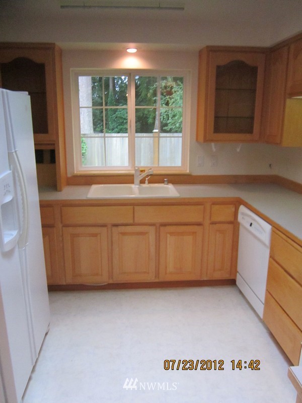 22005 Old Owen Road Monroe, WA 98272 - Photo 4 of 11 a kitchen with a sink window and cabinets