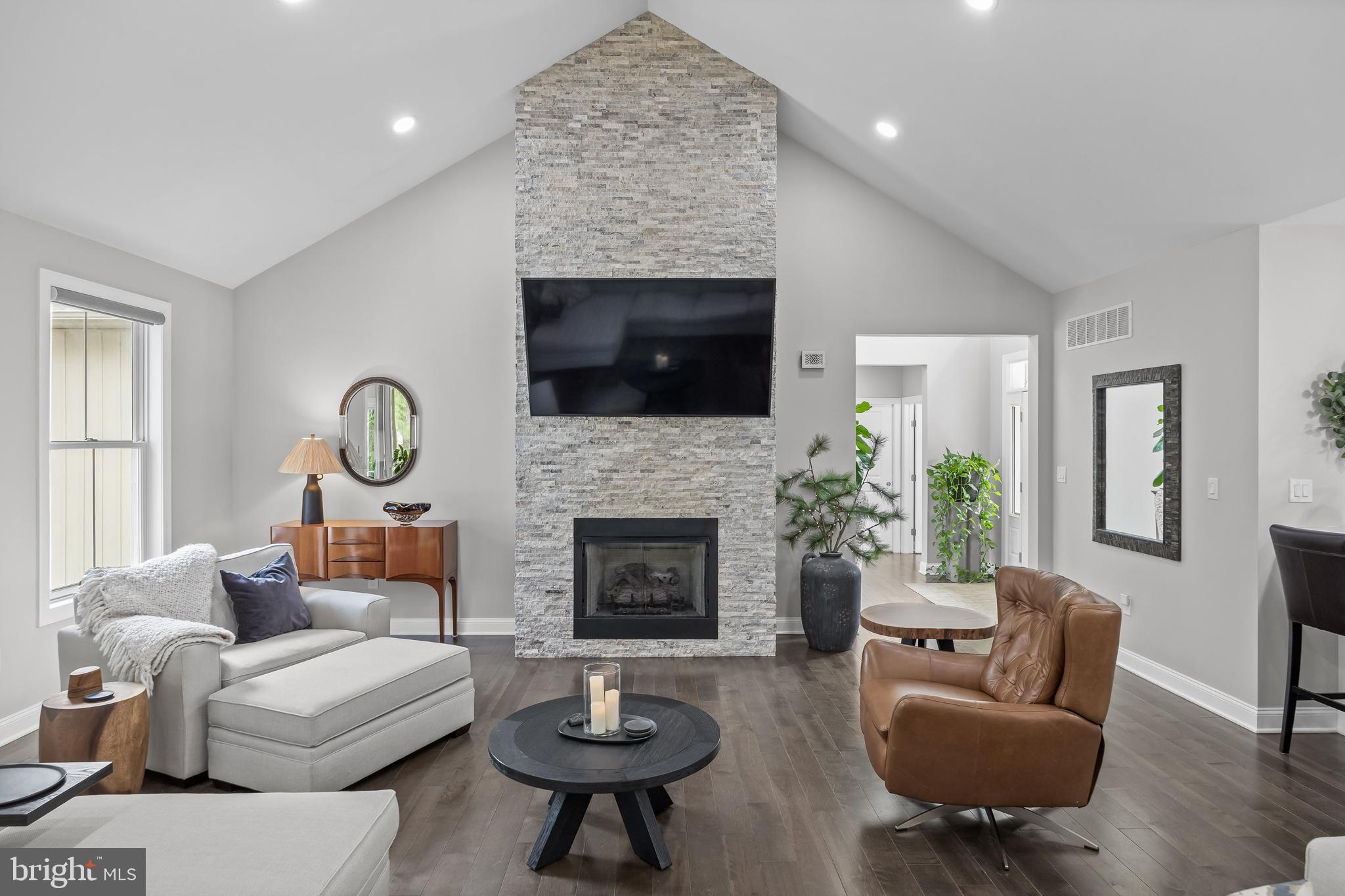 15 Sawmill Road Medford, NJ 08055 - Photo 8 of 49 a living room with furniture a flat screen tv and a fireplace
