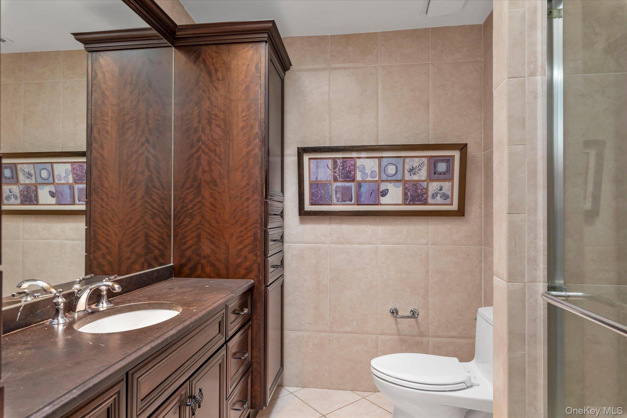 41 Spring Hollow Road Roslyn, NY 11576 - Photo 14 of 27 a bathroom with a granite countertop sink toilet and shower