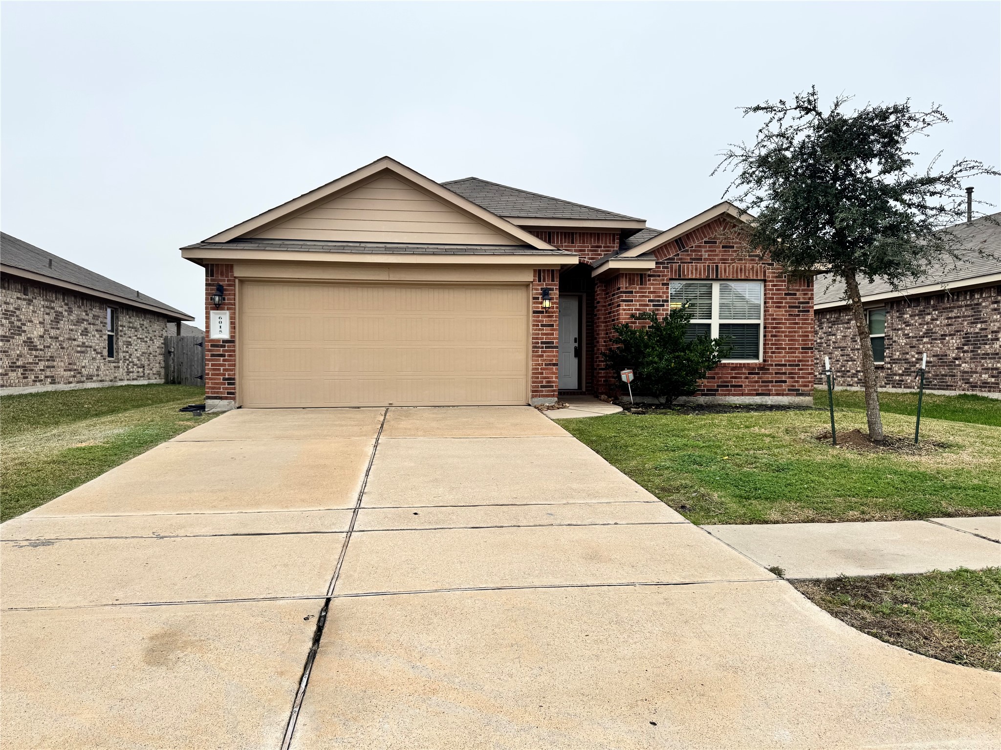 6015 Lilly Belle Street Katy, TX 77449 - Photo 2 of 10 a front view of a house with a yard and garage