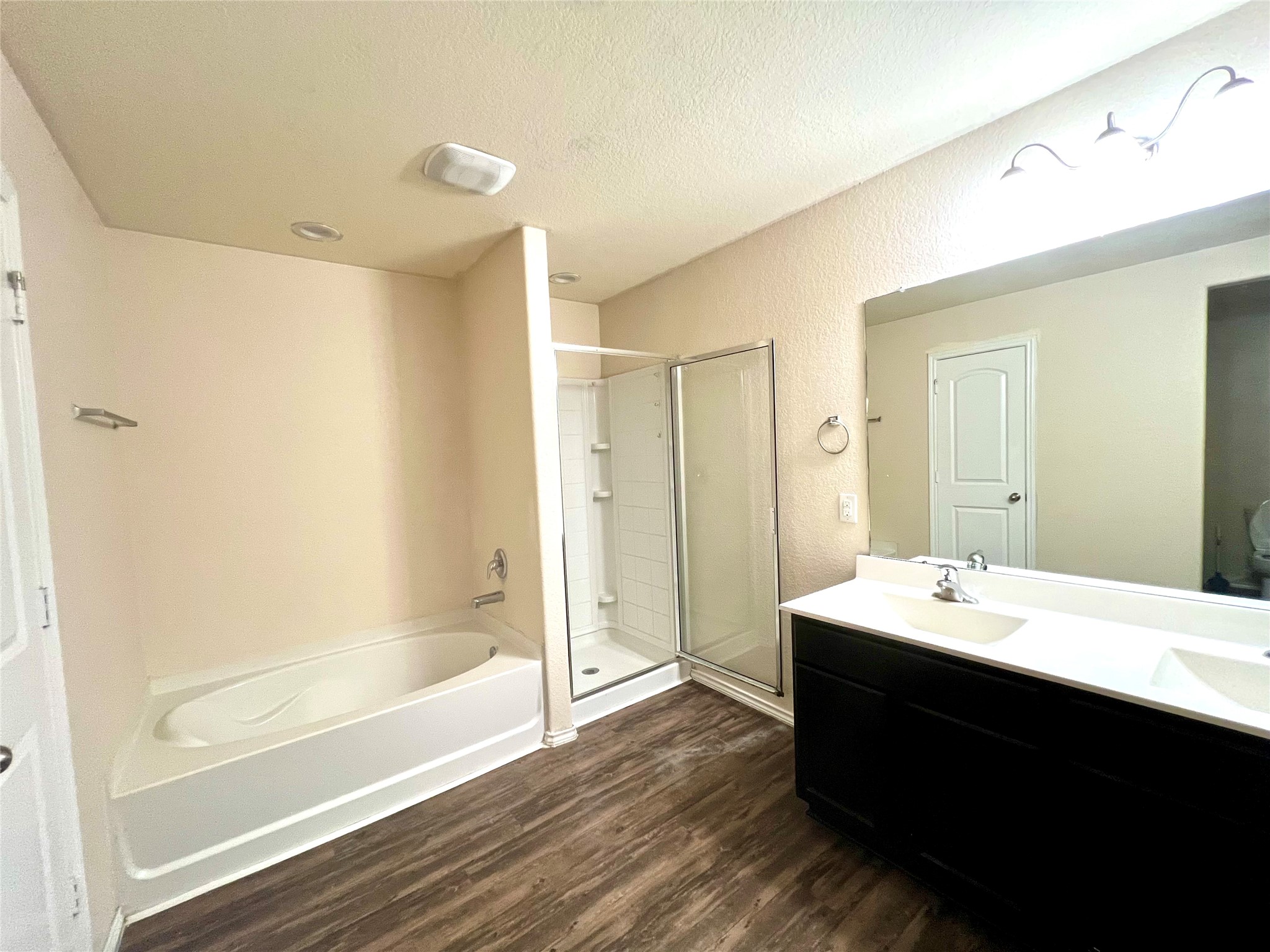 6015 Lilly Belle Street Katy, TX 77449 - Photo 8 of 10 a bathroom with a bathtub sink vanity and mirror