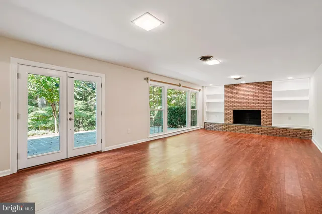 a spacious bedroom with a bed and a large window