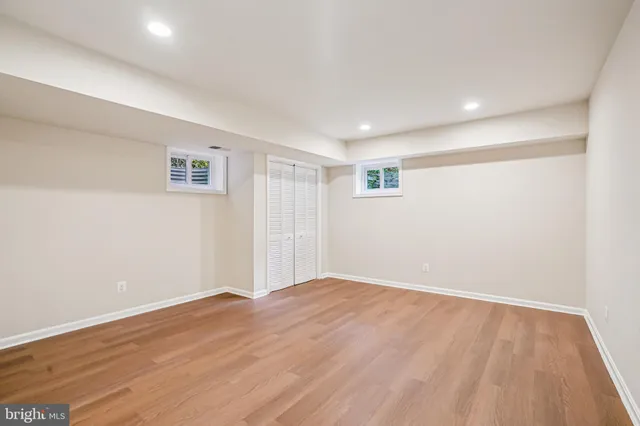 a kitchen with granite countertop a sink and white cabinets