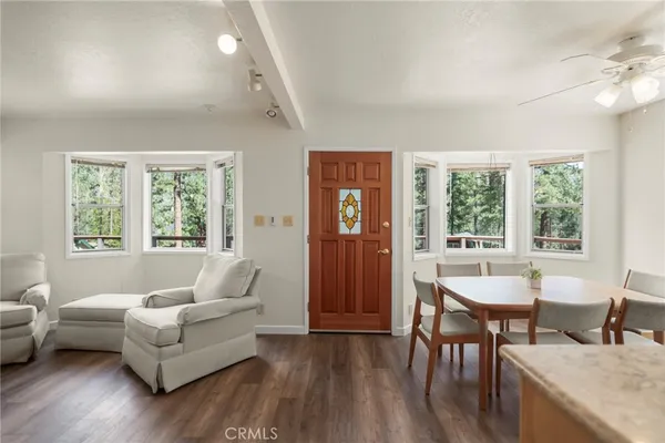 a kitchen with stainless steel appliances granite countertop a sink window and cabinets