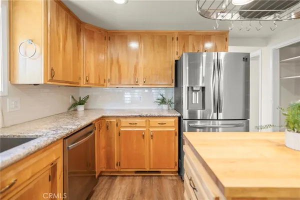 a kitchen with granite countertop a stove a sink and a microwave