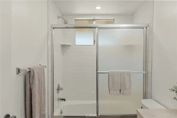 a bathroom with a granite countertop sink a shower and a mirror