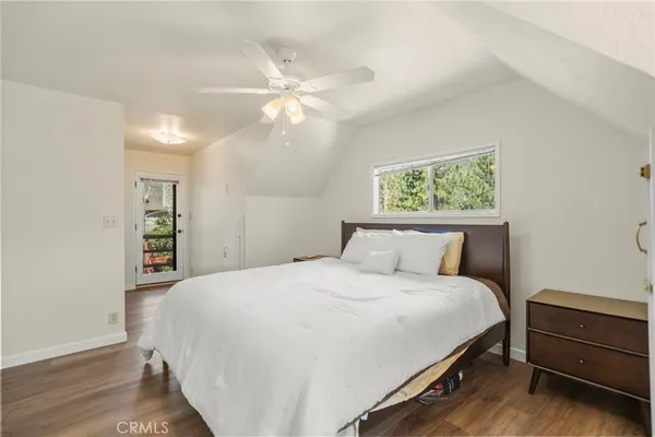 a bedroom with a large bed and a chandelier