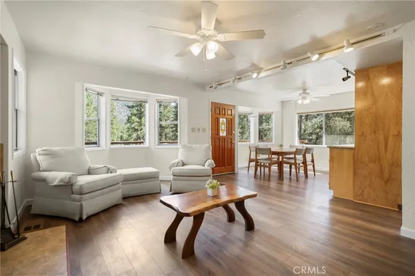 a living room with furniture a rug and a flat screen tv
