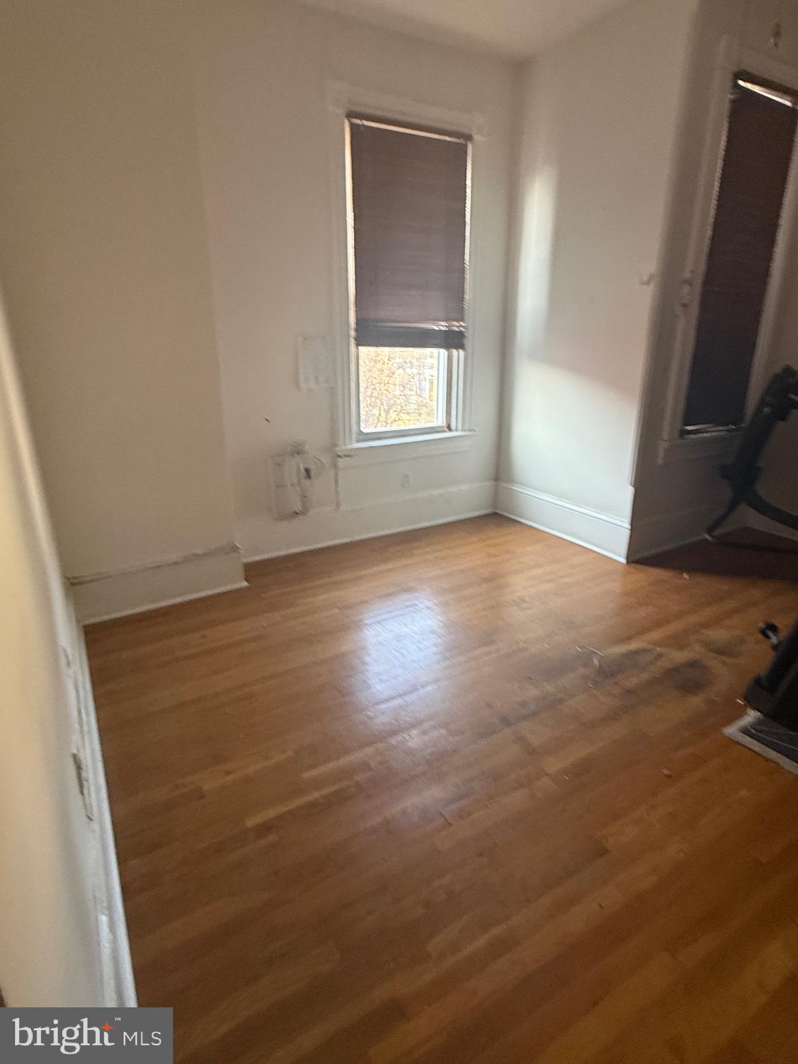 656 6th Street Northeast Washington, DC 20002 - Photo 12 of 30 an empty room with wooden floor and windows