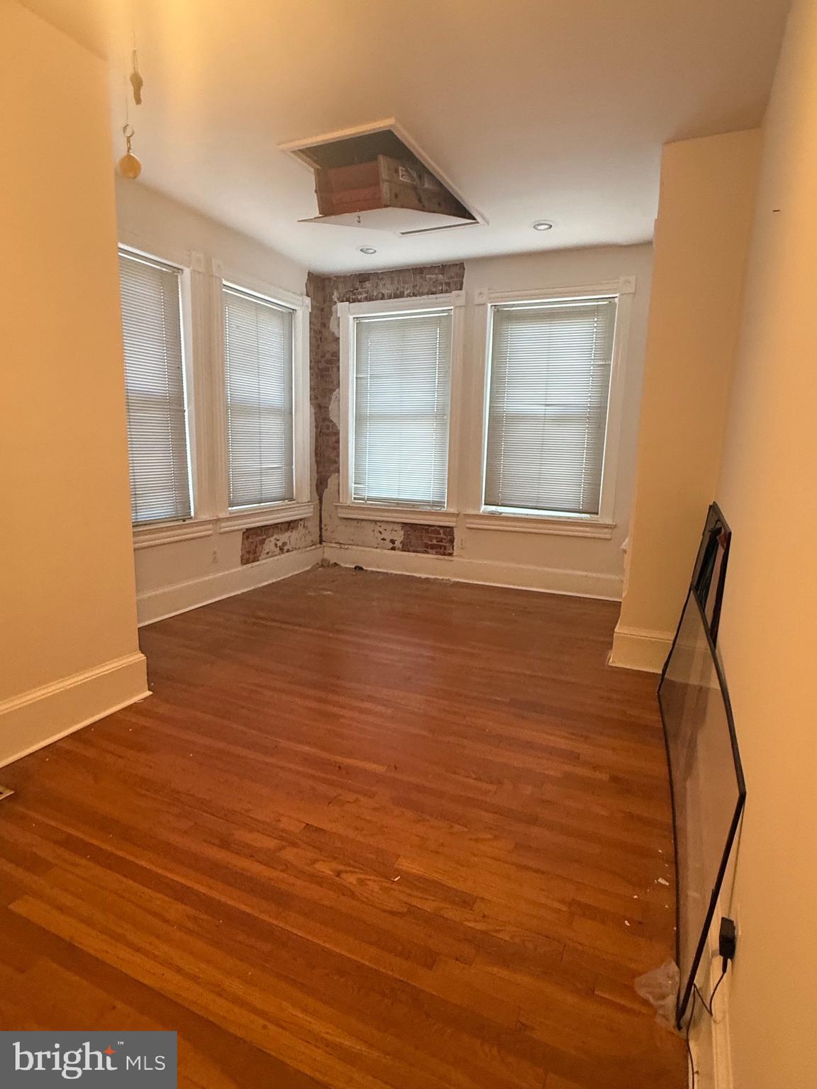 656 6th Street Northeast Washington, DC 20002 - Photo 16 of 30 a view of an empty room with wooden floor and a window