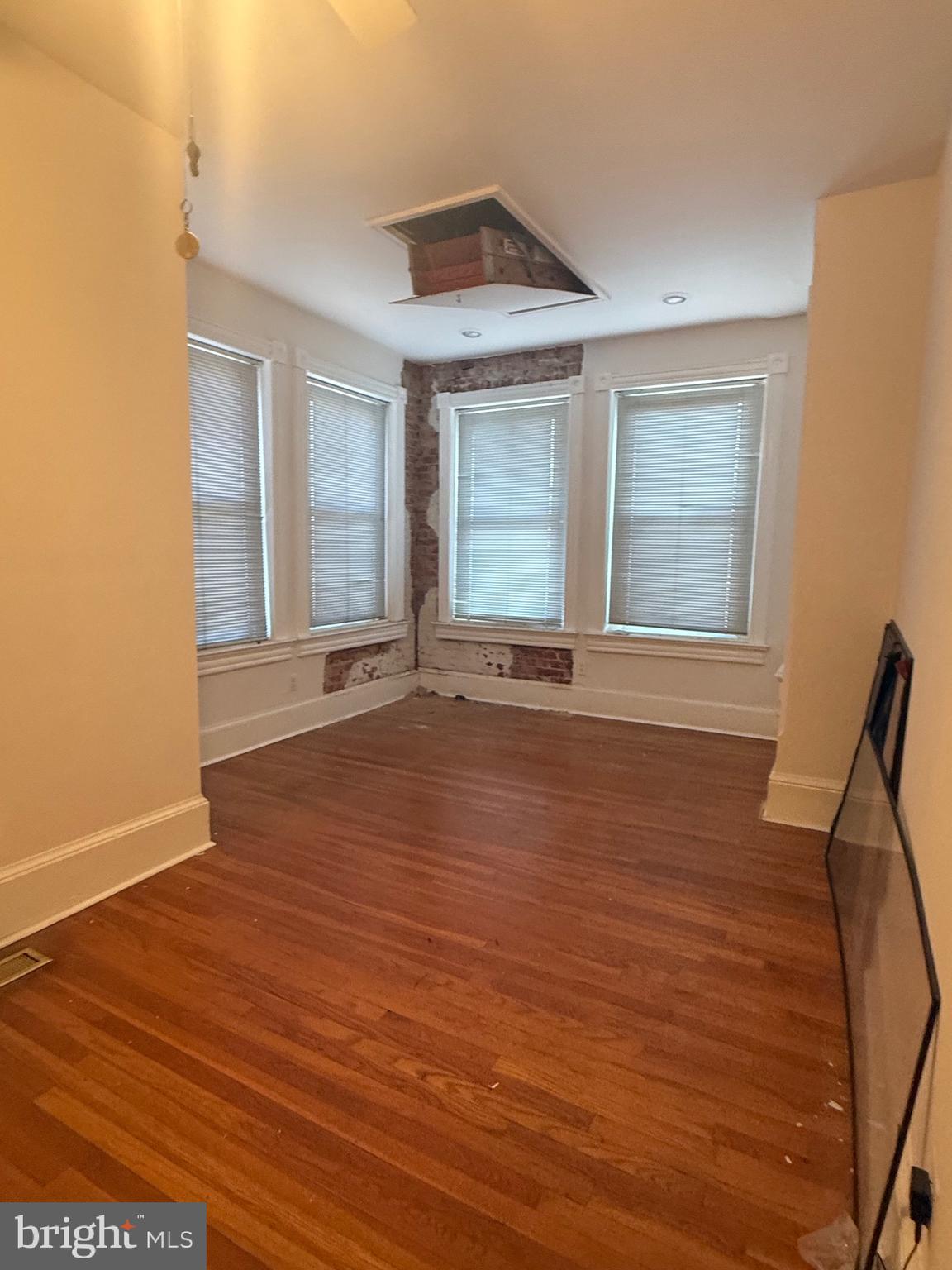 656 6th Street Northeast Washington, DC 20002 - Photo 17 of 30 a view of an empty room with wooden floor and a window