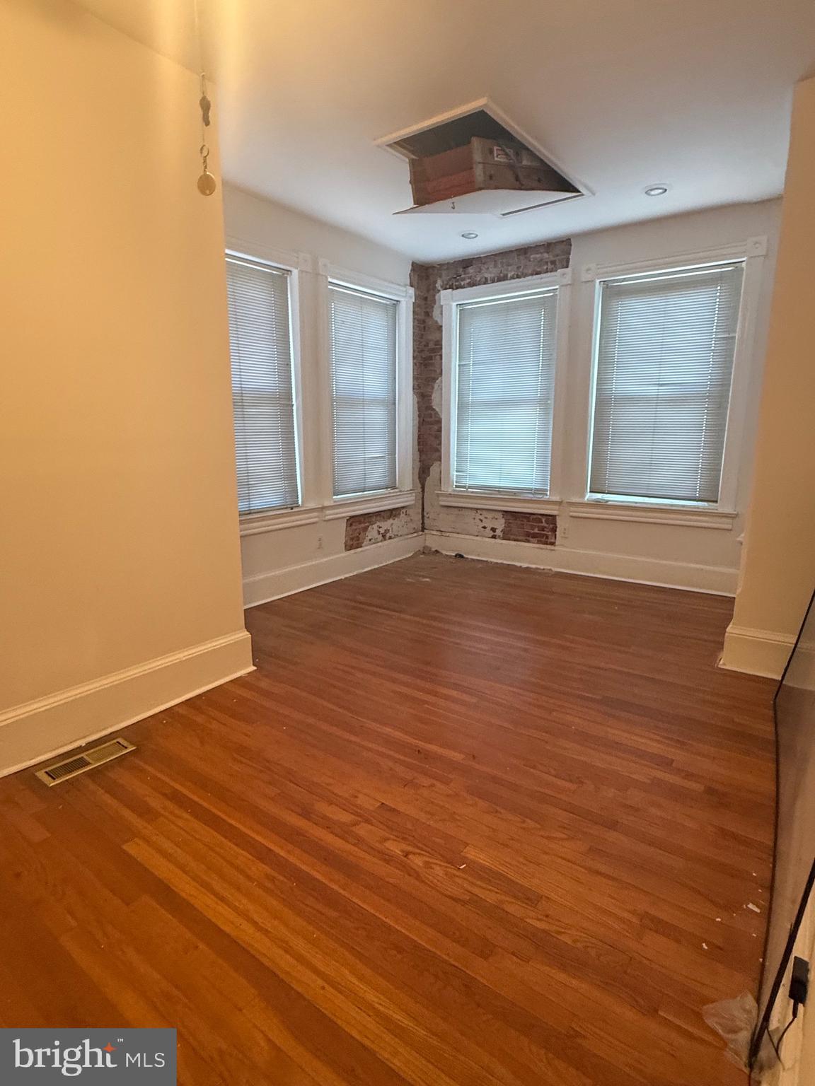 656 6th Street Northeast Washington, DC 20002 - Photo 22 of 30 a view of an empty room with wooden floor and a window