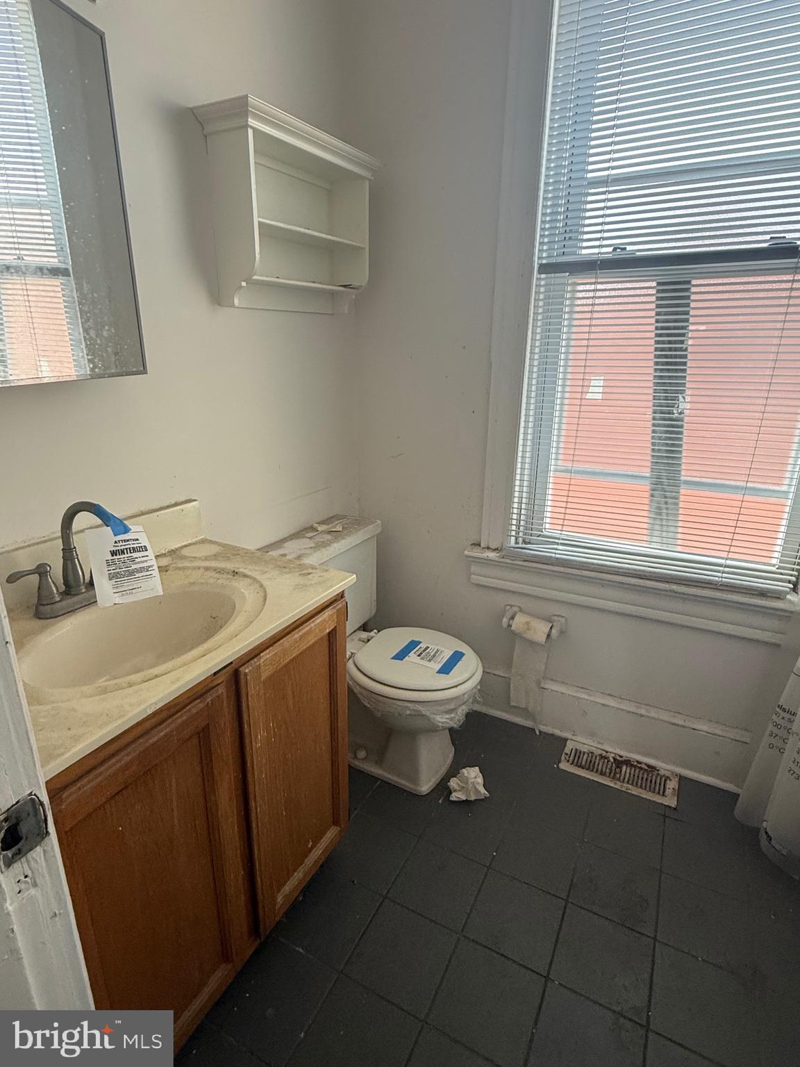 656 6th Street Northeast Washington, DC 20002 - Photo 25 of 30 a bathroom with a toilet sink and mirror