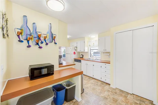 a kitchen with stainless steel appliances a stove a microwave and cabinets