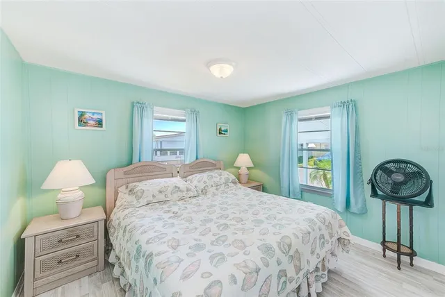 a bedroom with a bed and chandelier