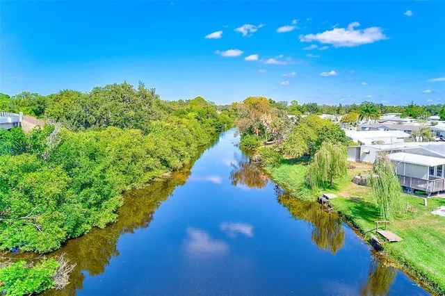 a view of a lake with a house in the background