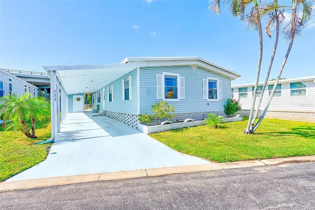 a front view of a house with a yard and trees