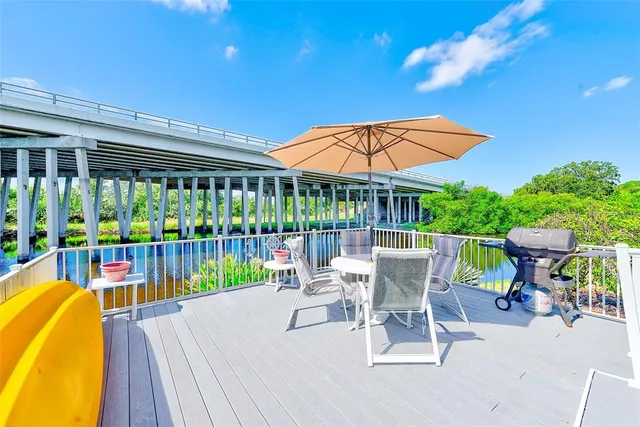 a view of a patio with a table chairs and a garden