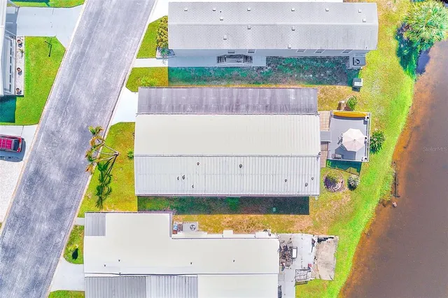 an aerial view of a house with a swimming pool yard and outdoor seating