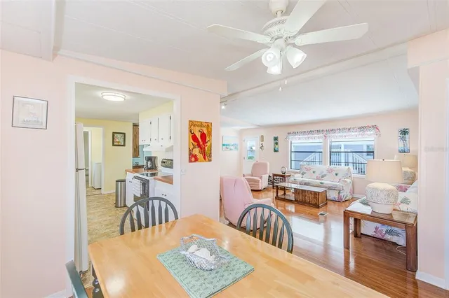 a living room with furniture a rug a table and a large window