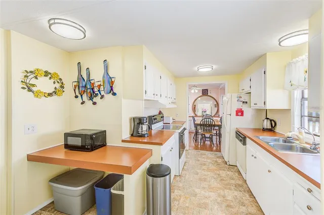 a kitchen with stainless steel appliances a stove a sink and a refrigerator