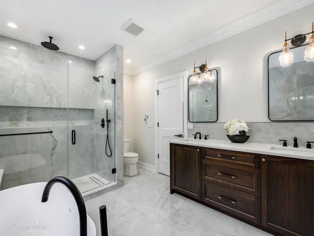 a spacious bathroom with a granite countertop sink mirror and bathtub