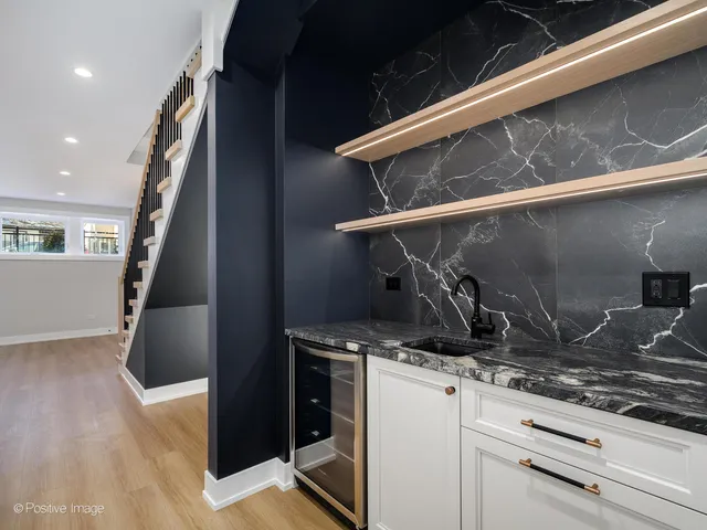 a kitchen with a stove and a wooden floor