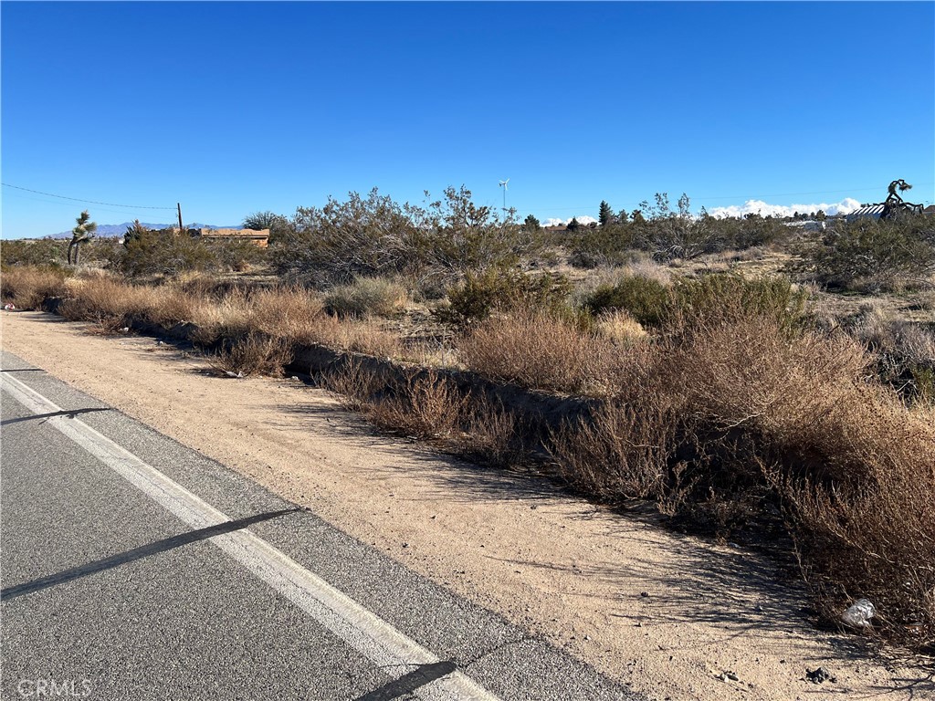 5000 Duncan Road Phelan, CA 92371 - Photo 1 of 1 a view of a dry yard with wooden fence