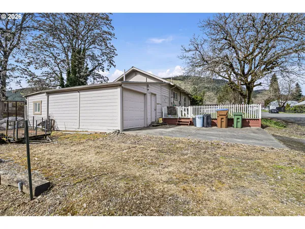 a view of a house with a yard covered in snow