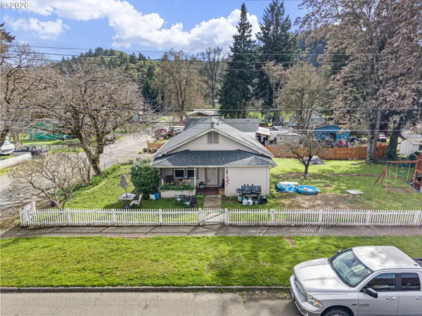 a front view of a house with a yard table and chairs