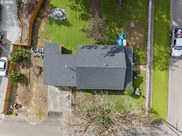 an aerial view of a house with a yard