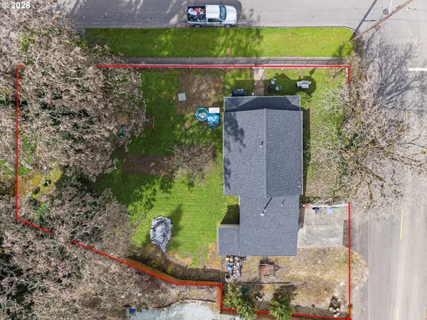 an aerial view of a house with a yard and lake view