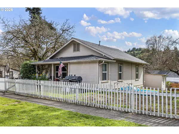 a front view of a house with a fence